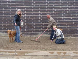 PlantingForPollinators BBb seed staff planting widflower seed for pollinator garden.