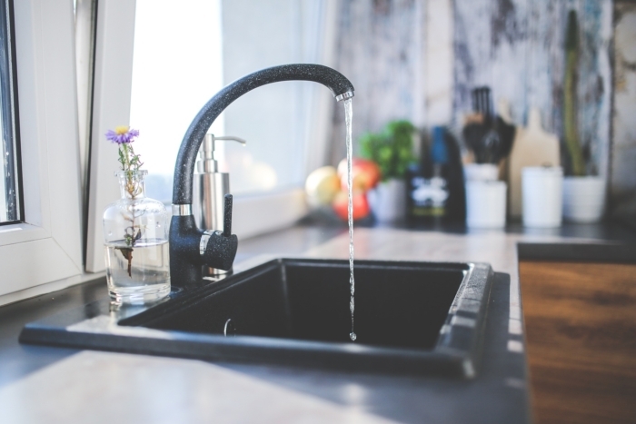 Kitchen faucet with running water.