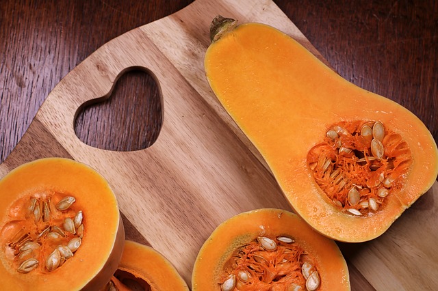 Halves of a Butternut squash on a cutting board.