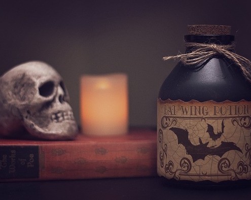 Skull, candle and jug of bat potion.